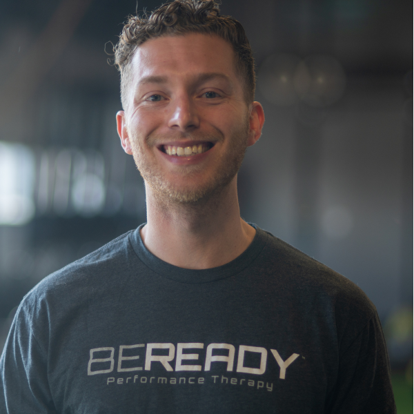 A smiling man wearing a be ready t - shirt.