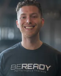 A man wearing a t - shirt that says be ready.