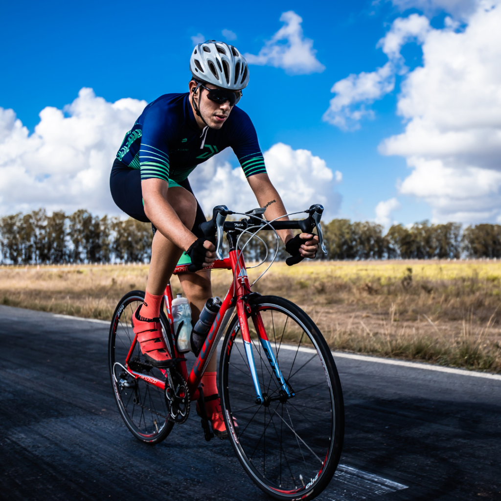 A cyclist riding a bike down a road.